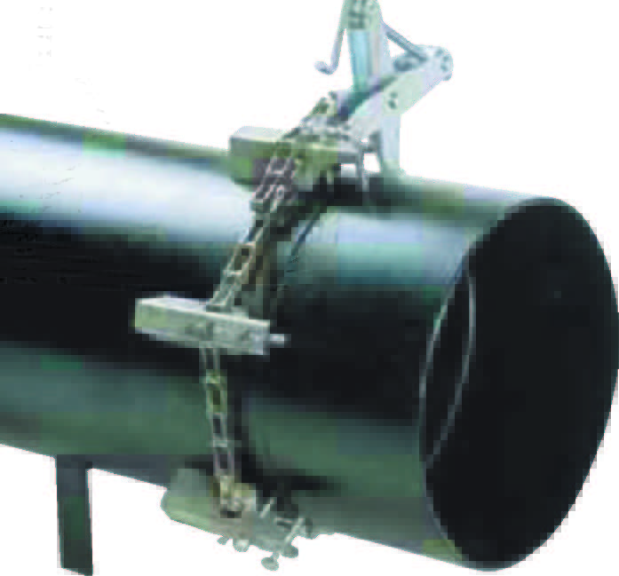 A Manual pipe clamp single is fastened around a large black metal pipe, holding two pipe sections together securely for alignment or welding.