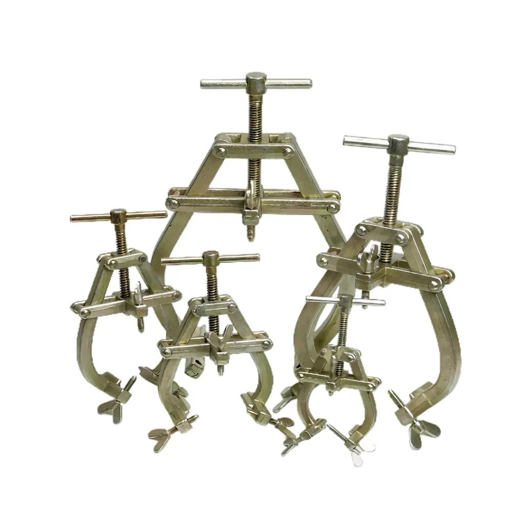 Four WT Steel Clamps of different sizes, each with three metal prongs, visible adjustment screws, and wing nuts, stand upright on a white background.