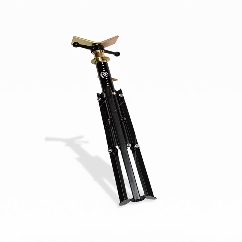 The WT Flexi Stand, a black and gold metal tripod stabiliser with an adjustable top plate and three foldable legs, is displayed standing on a white background with its shadow visible.